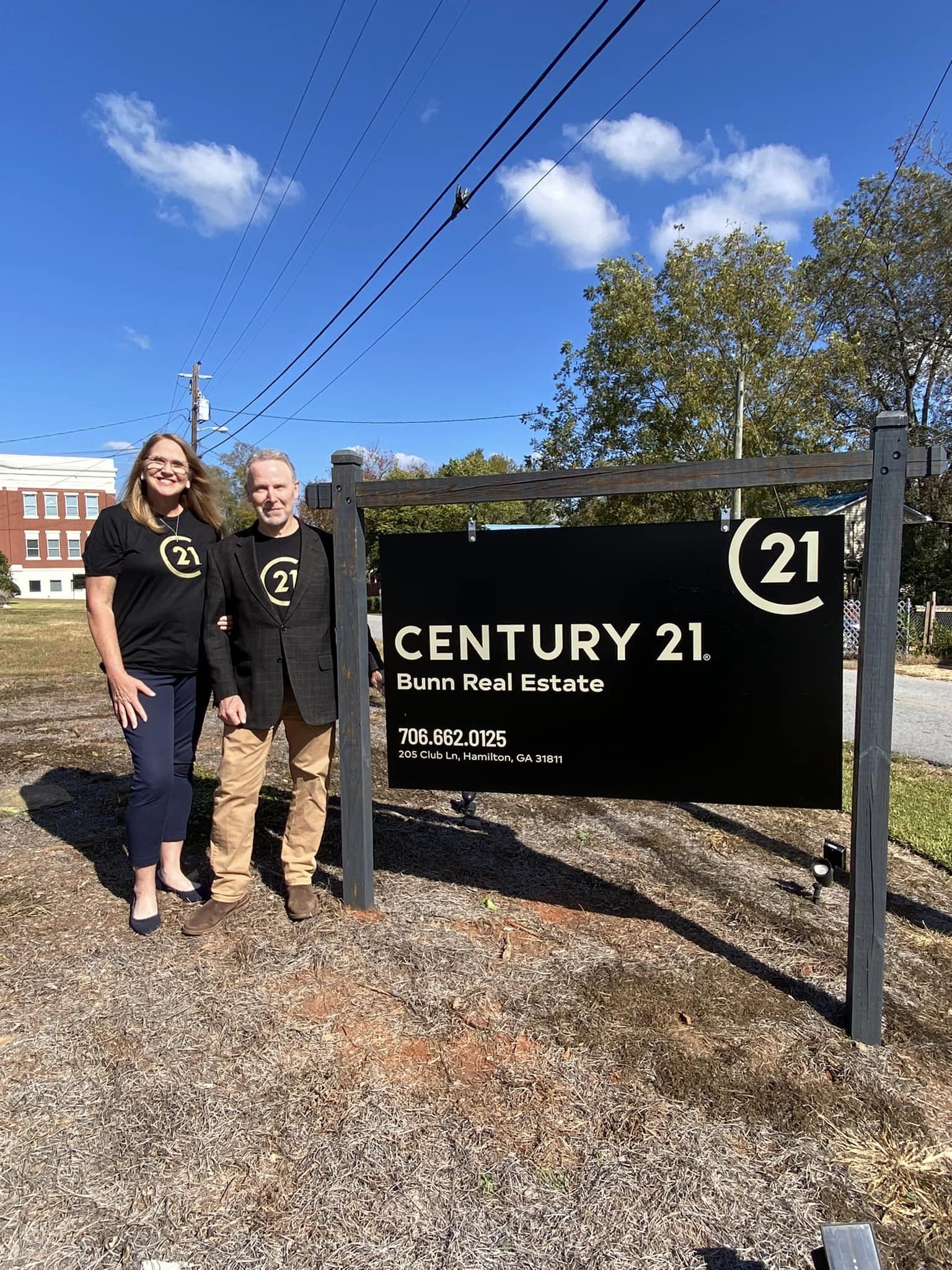 John Bunn in front of C21 sign